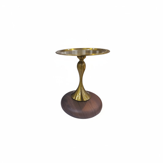 Small round table with a gold top and wooden base on a white background